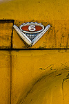 An emblem on the side of an old school bus.