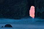 Sunset through a natural arch at Second Beach, Olympic National Park, WA.